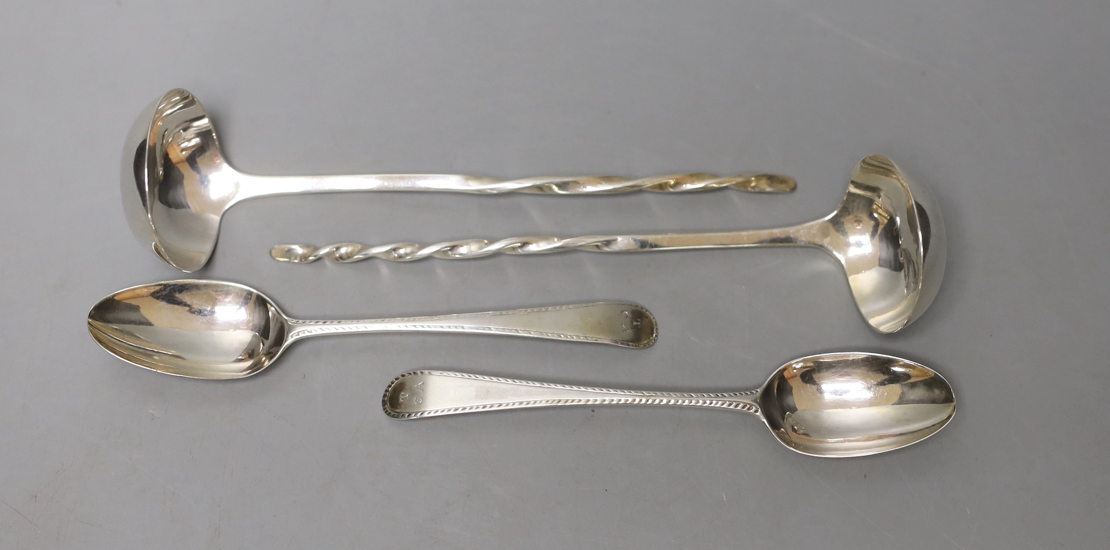 A pair of George III Scottish silver sauce ladles, with spiral handles, Alexander Spence, Edinburgh, 1807, 14.5cm and a pair of George III silver feather edge teaspoons, London, 1782.